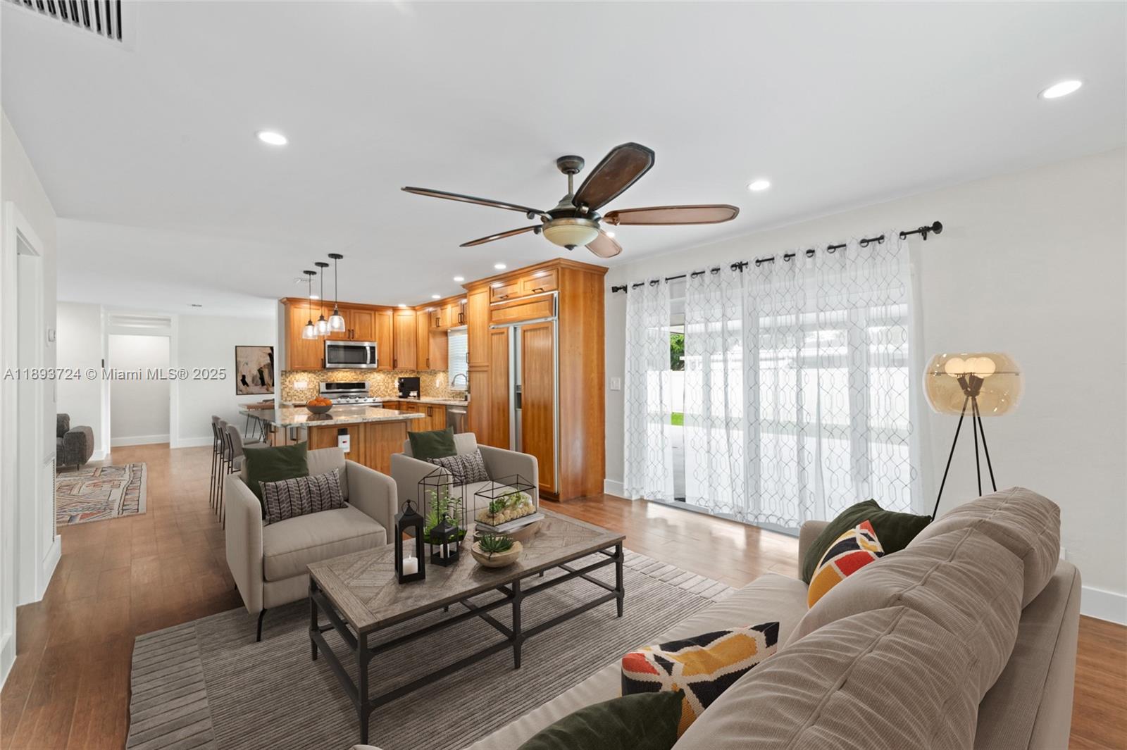 8440 Southwest 201st Street Cutler Bay, FL 33189 - Photo 4 of 31 a living room with furniture ceiling fan and a window