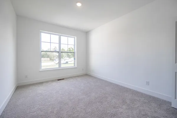 an empty room with an entrance and closet