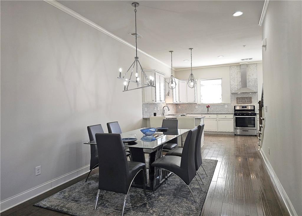1212 Stone Castle Circle Smyrna, GA 30080 - Photo 11 of 39 a view of a dining room with furniture wooden floor and chandelier