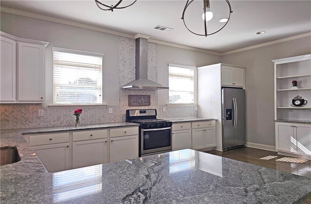 1212 Stone Castle Circle Smyrna, GA 30080 - Photo 14 of 39 a kitchen with a sink a refrigerator and cabinets