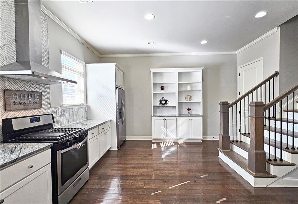 1212 Stone Castle Circle Smyrna, GA 30080 - Photo 15 of 39 a kitchen with stainless steel appliances granite countertop a stove and a refrigerator