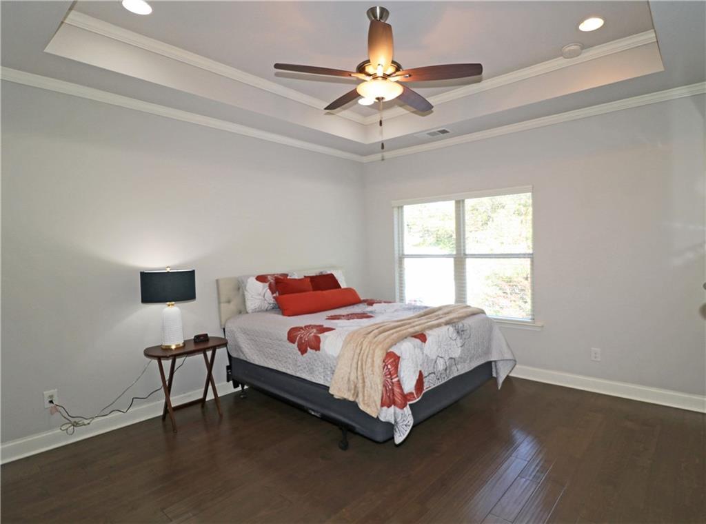 1212 Stone Castle Circle Smyrna, GA 30080 - Photo 19 of 39 a bedroom with a bed and a chandelier