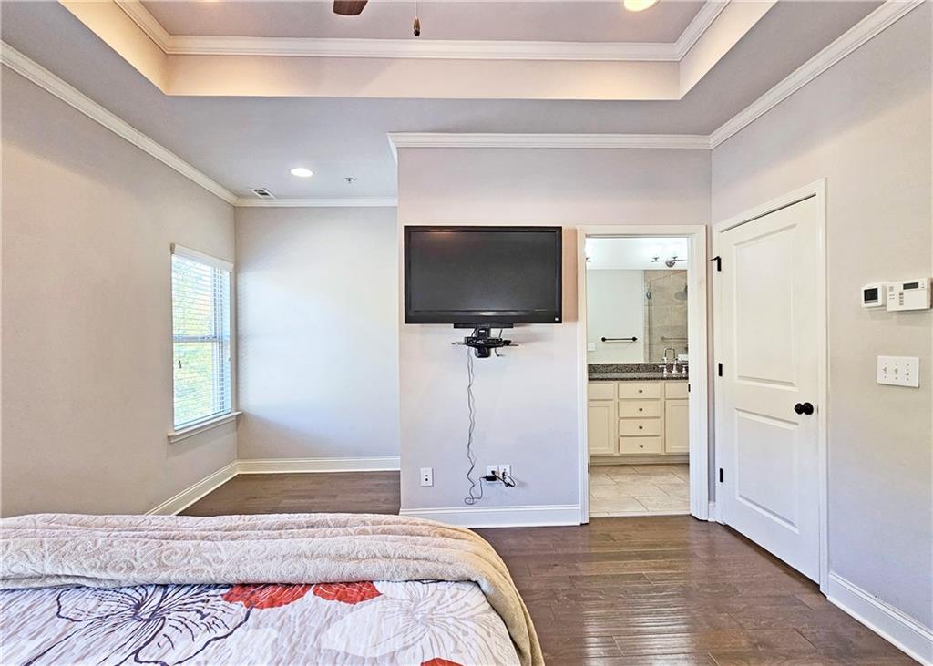 1212 Stone Castle Circle Smyrna, GA 30080 - Photo 22 of 39 a bedroom with a bed and a flat screen tv