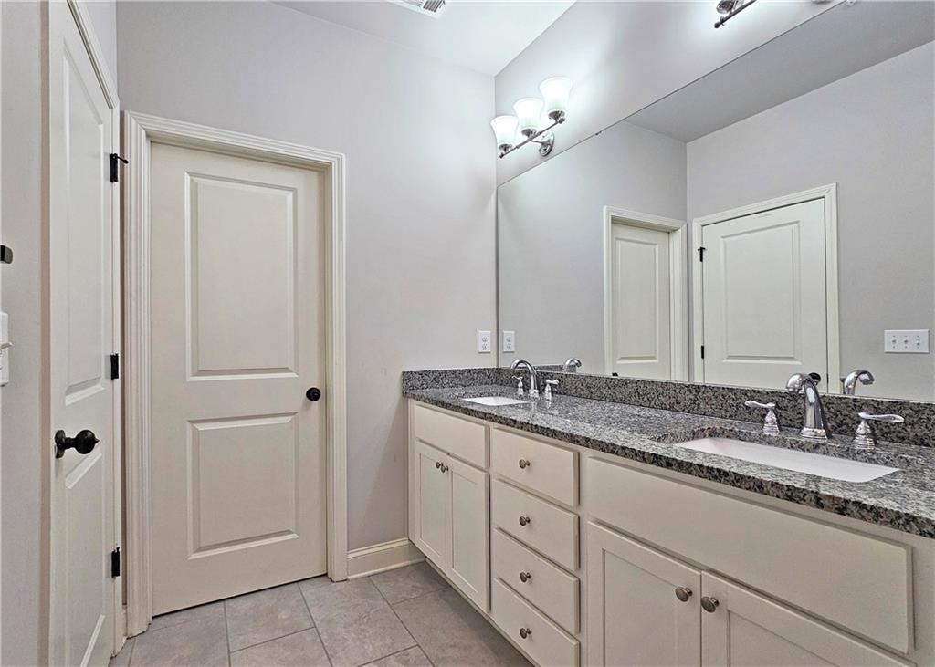 1212 Stone Castle Circle Smyrna, GA 30080 - Photo 25 of 39 a bathroom with a granite countertop sink double and mirror