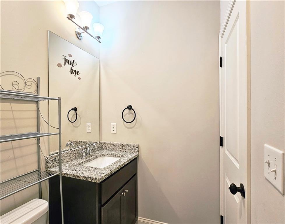 1212 Stone Castle Circle Smyrna, GA 30080 - Photo 28 of 39 a bathroom with a granite countertop sink and a mirror