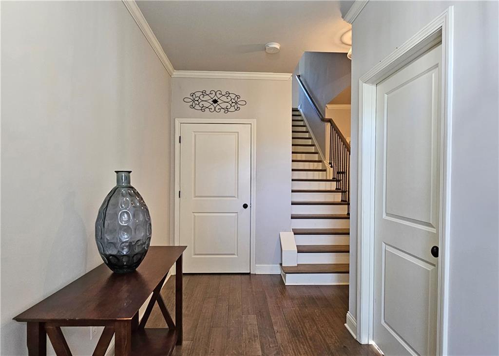 1212 Stone Castle Circle Smyrna, GA 30080 - Photo 4 of 39 a view of a hallway with wooden floor windows and entryway
