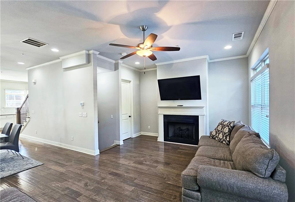 1212 Stone Castle Circle Smyrna, GA 30080 - Photo 9 of 39 a living room with furniture a fireplace and a flat screen tv