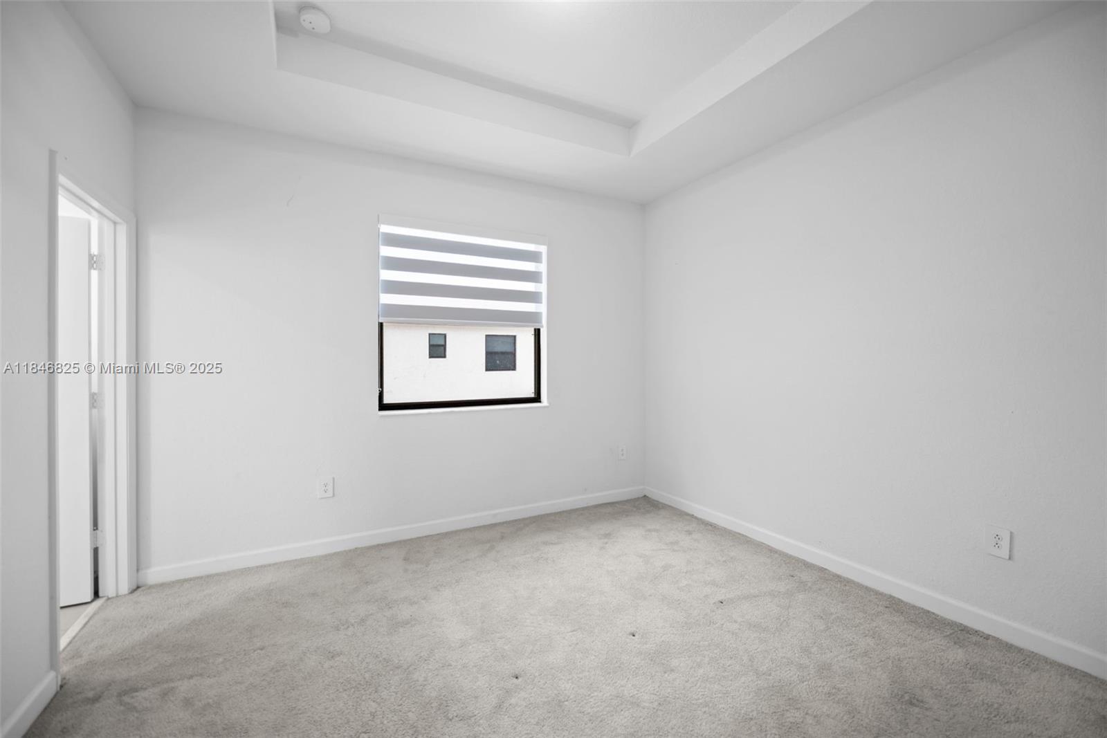 12965 Southwest 233rd Terrace Homestead, FL 33032 - Photo 15 of 25 an empty room with a window