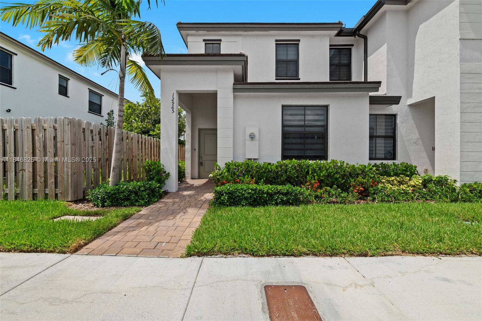 12965 Southwest 233rd Terrace Homestead, FL 33032 - Photo 2 of 25 a front view of a house with a yard