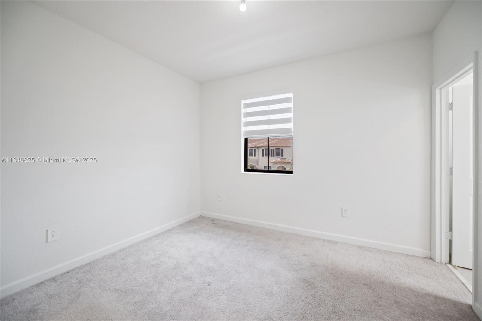 12965 Southwest 233rd Terrace Homestead, FL 33032 - Photo 21 of 25 an empty room with a window