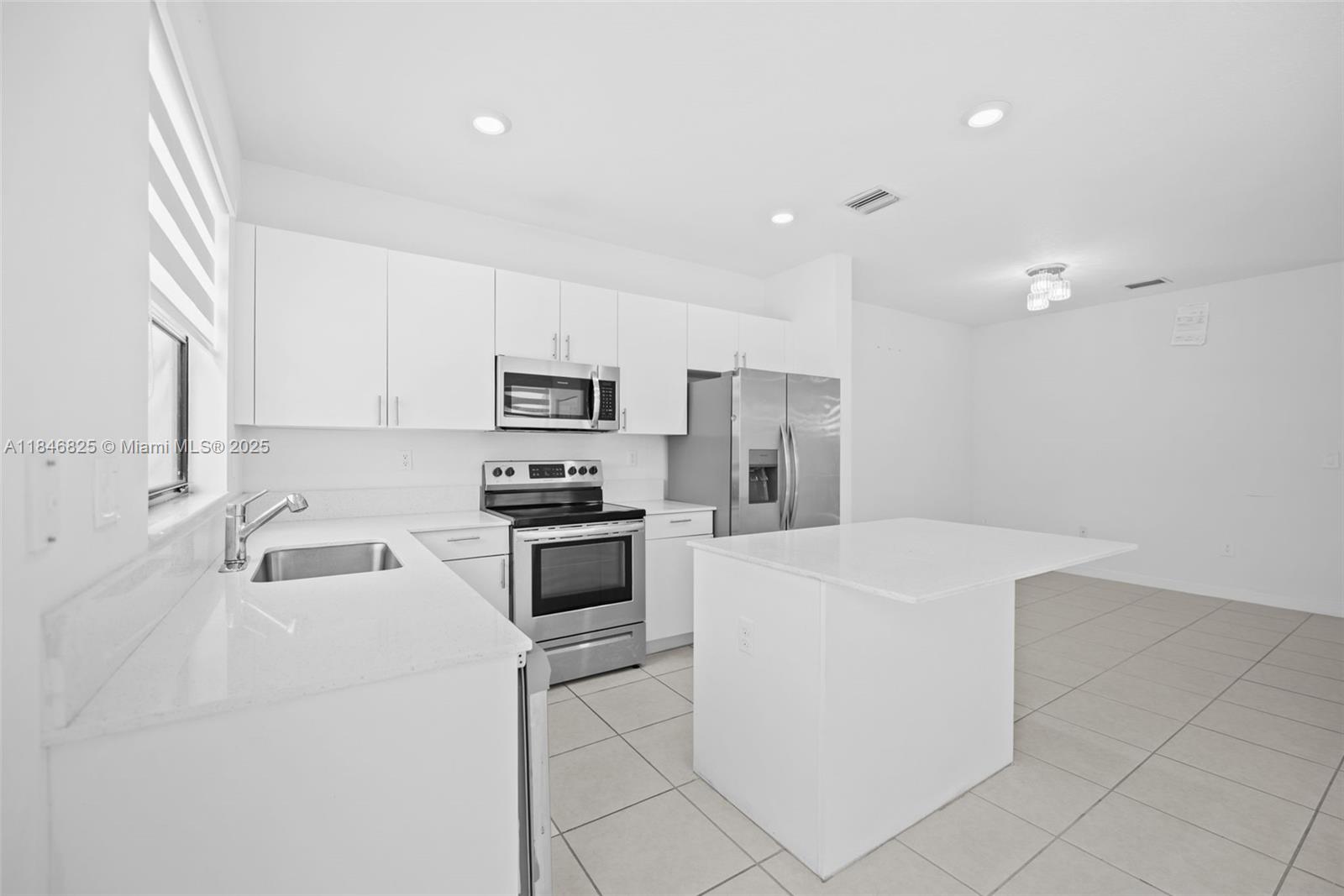 12965 Southwest 233rd Terrace Homestead, FL 33032 - Photo 8 of 25 a kitchen that has a sink cabinets stainless steel appliances and a counter top space