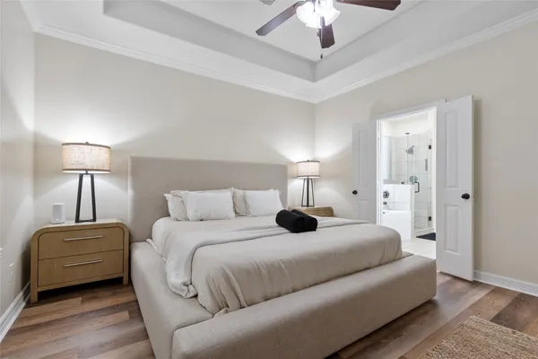 a bedroom with a bed and a chandelier