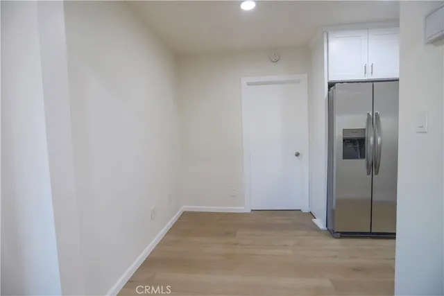 a kitchen with a refrigerator sink and cabinets