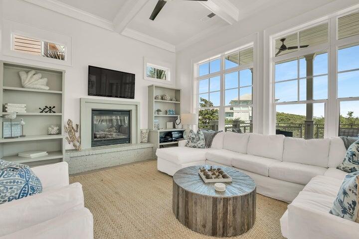 410 Beachfront Trail Santa Rosa Beach, FL 32459 - Photo 11 of 102 a living room with furniture a fireplace and a flat screen tv