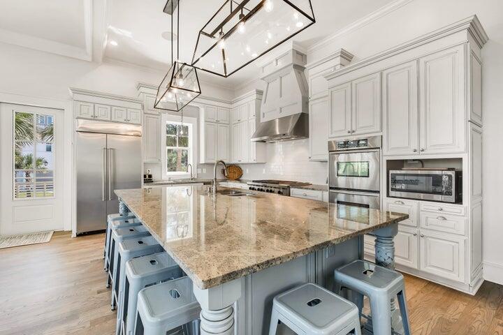 410 Beachfront Trail Santa Rosa Beach, FL 32459 - Photo 19 of 102 a kitchen with stainless steel appliances granite countertop a sink a stove counter space and cabinets