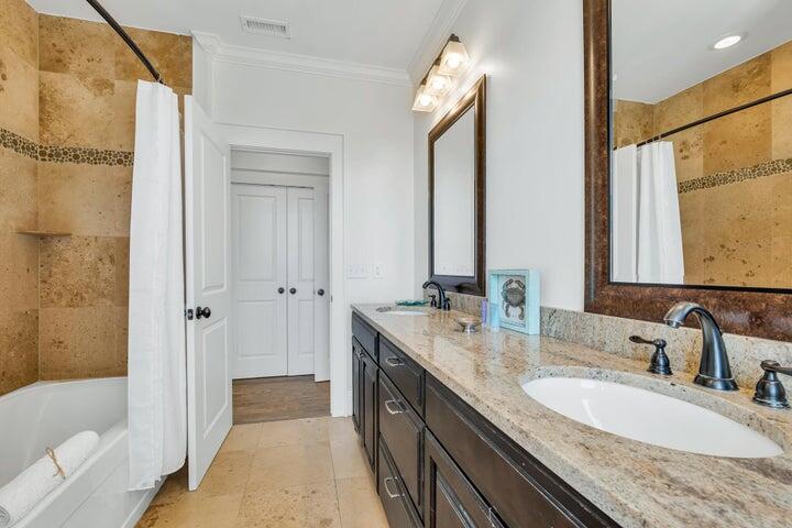410 Beachfront Trail Santa Rosa Beach, FL 32459 - Photo 68 of 102 a bathroom with a granite countertop double vanity sink a mirror and a bathtub
