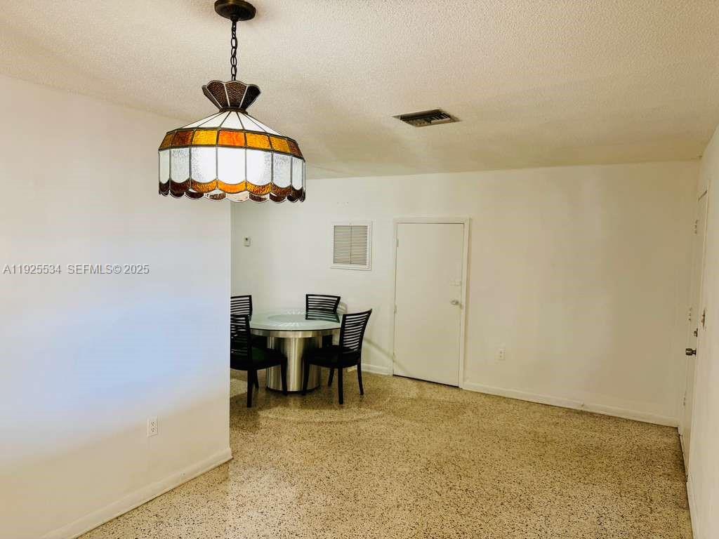 751 Southeast 6th Place, Unit 2 Hialeah, FL 33010 - Photo 2 of 8 a view of a dining room with furniture and chandelier
