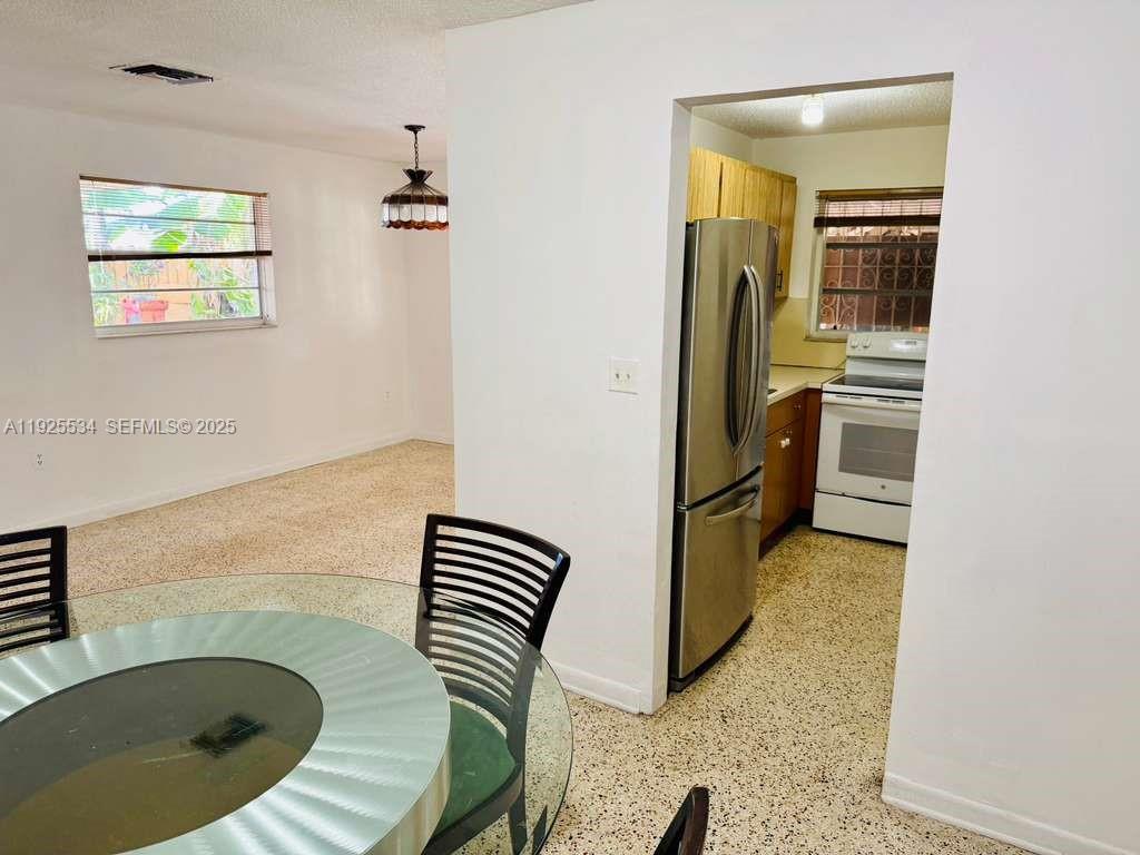 751 Southeast 6th Place, Unit 2 Hialeah, FL 33010 - Photo 3 of 8 a view of kitchen and bathroom