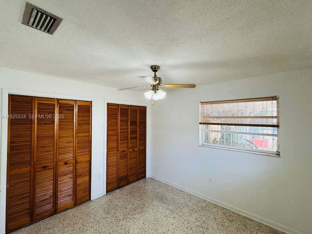 751 Southeast 6th Place, Unit 2 Hialeah, FL 33010 - Photo 6 of 8 an empty room with windows