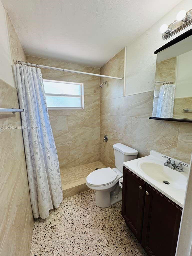 751 Southeast 6th Place, Unit 2 Hialeah, FL 33010 - Photo 7 of 8 a bathroom with a sink toilet and shower