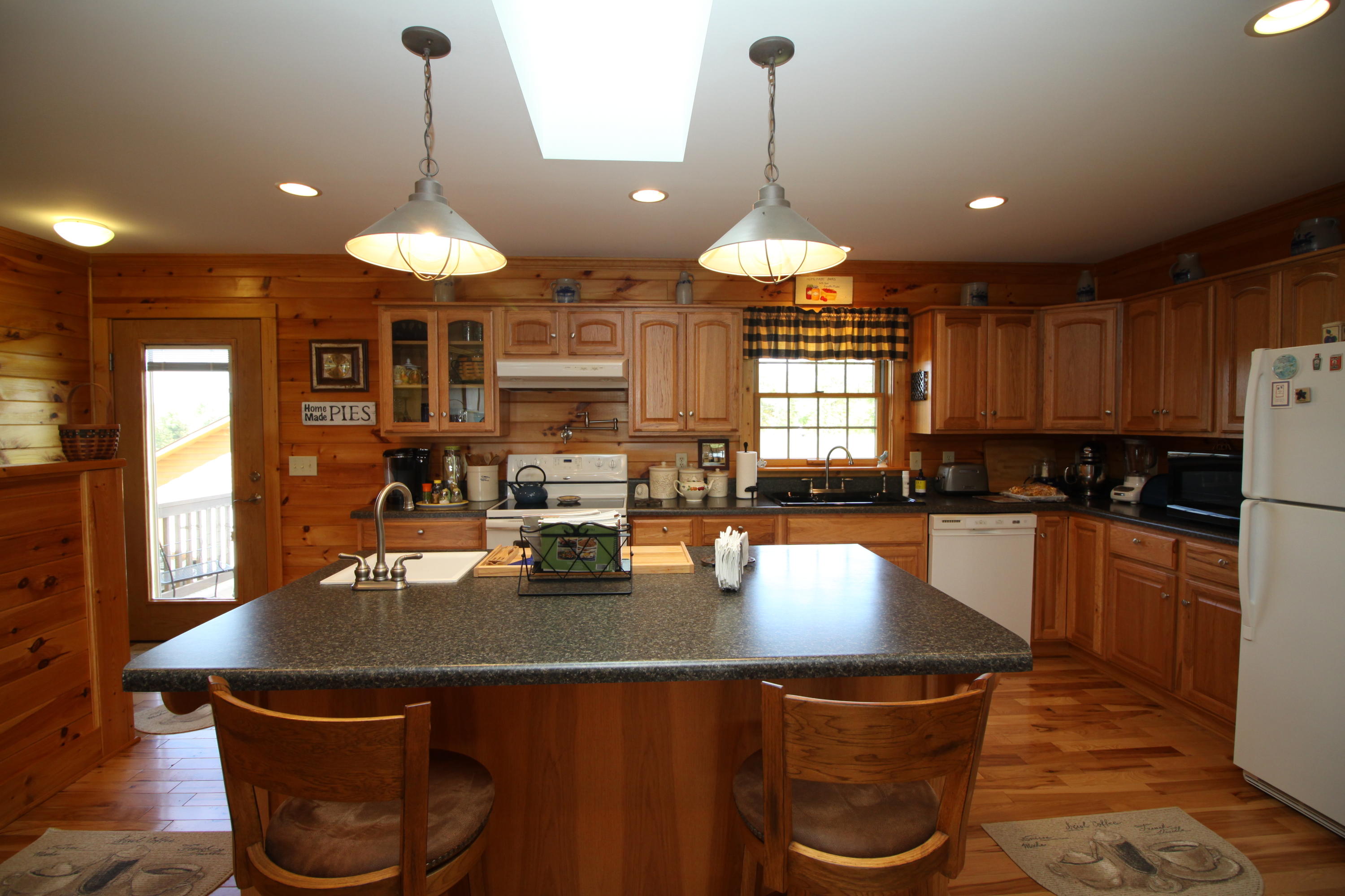 2615 Hatchett Road Penhook, VA 24137 - Photo 6 of 38 a kitchen with a dining table and chairs