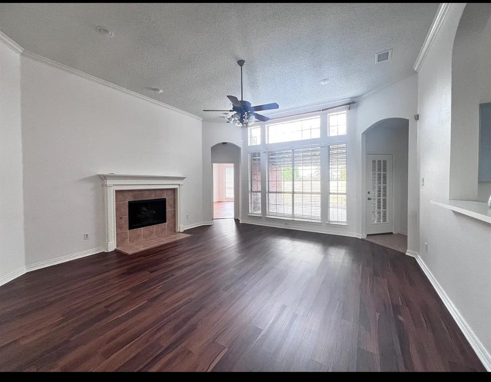 2714 Winterberry Drive Rowlett, TX 75089 - Photo 2 of 6 an empty room with wooden floor fireplace and windows