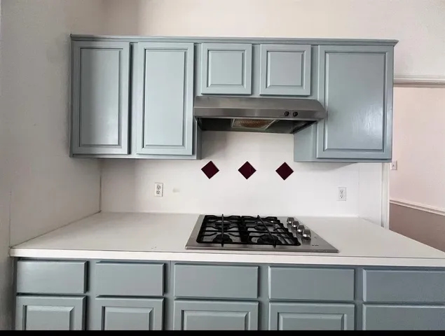 a white stove top oven sitting inside of a kitchen