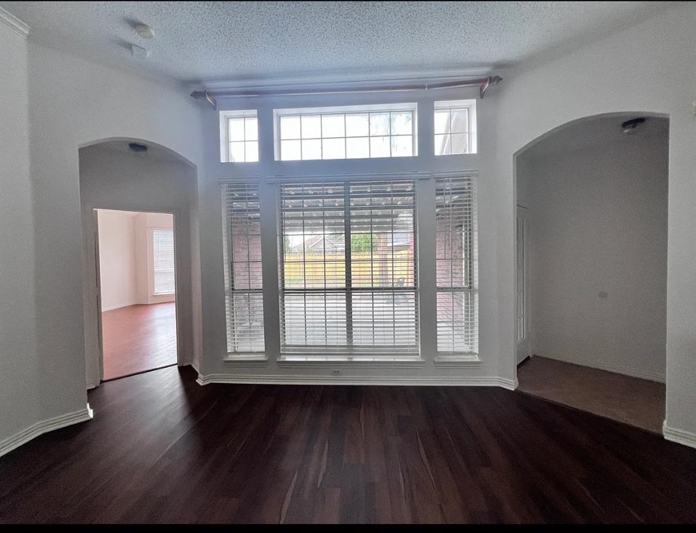 2714 Winterberry Drive Rowlett, TX 75089 - Photo 5 of 6 an empty room with wooden floor and windows