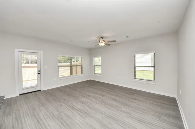 a very nice looking living room with a large window and a table