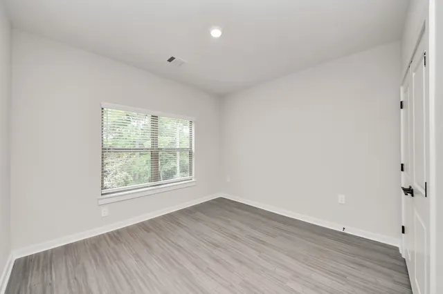 a kitchen with stainless steel appliances granite countertop a refrigerator a sink a stove and a wooden floors