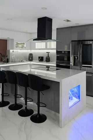 a kitchen that has a table and chairs in it
