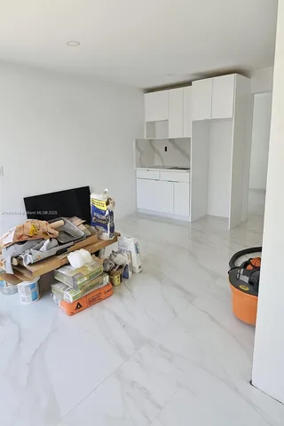a bathroom with a double vanity sink a toilet and shower
