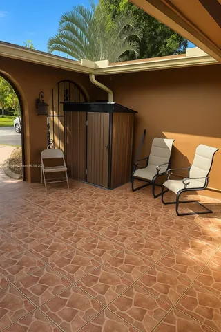 a view of a patio with table and chairs