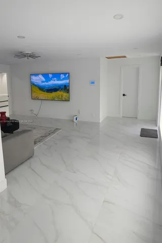 a kitchen with stainless steel appliances kitchen island granite countertop a sink and cabinets