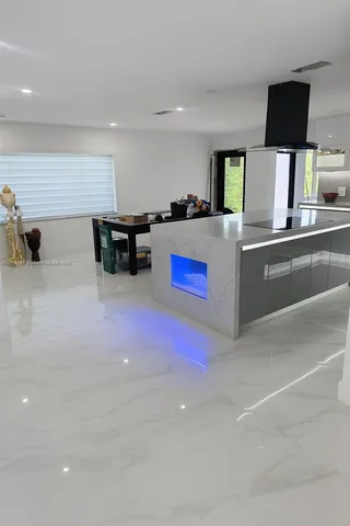 a kitchen with stainless steel appliances a sink and a refrigerator