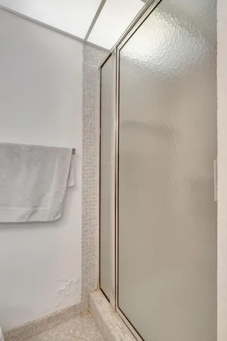 a bathroom with a glass shower door