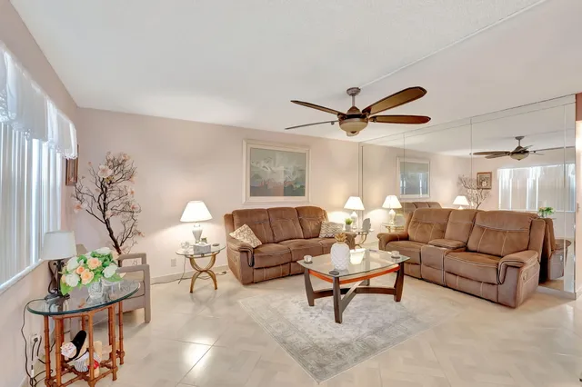 a living room with furniture and a potted plant