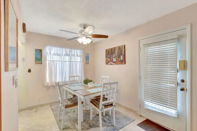 a view of a dining room with furniture and window