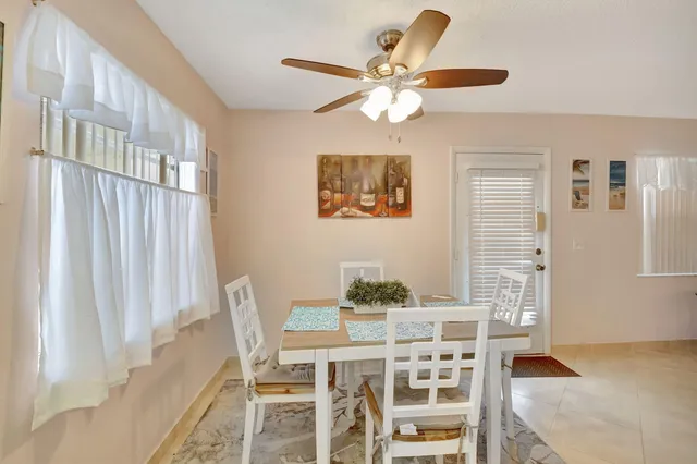 a view of a dining room with furniture and a chandelier