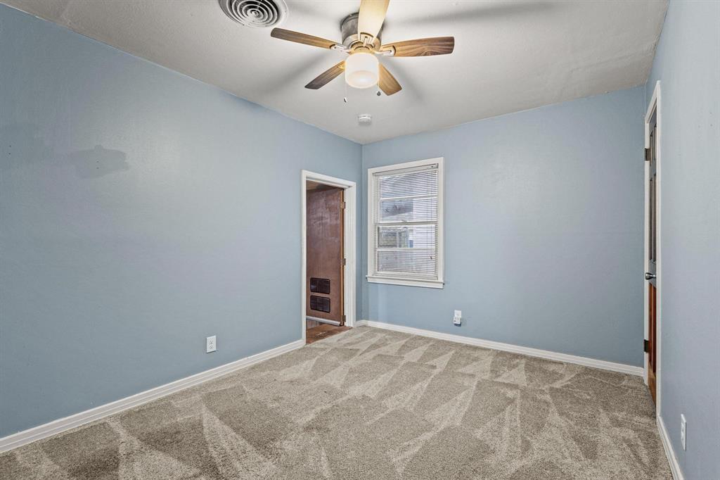 531 West Bullock Street Denison, TX 75020 - Photo 20 of 28 a view of a room with a ceiling fan and a window