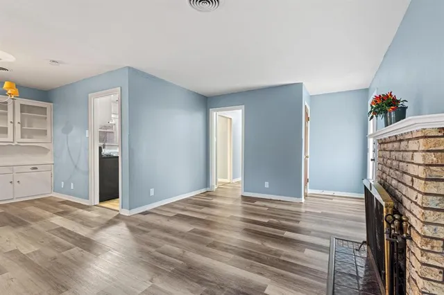 a view of an empty room with closet and a window