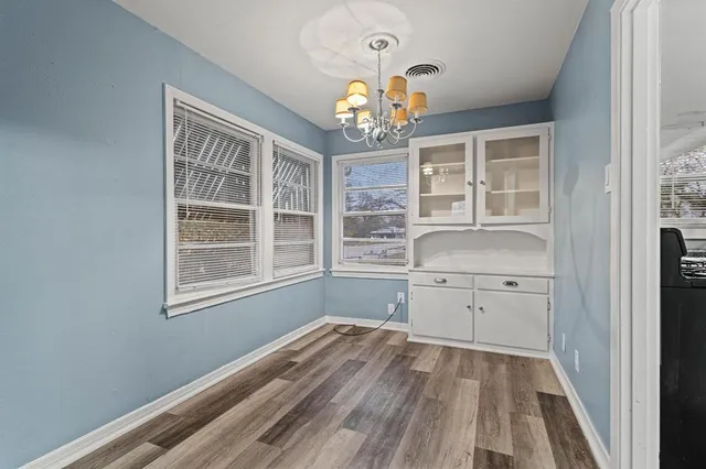 a room with a window wooden floor and a window