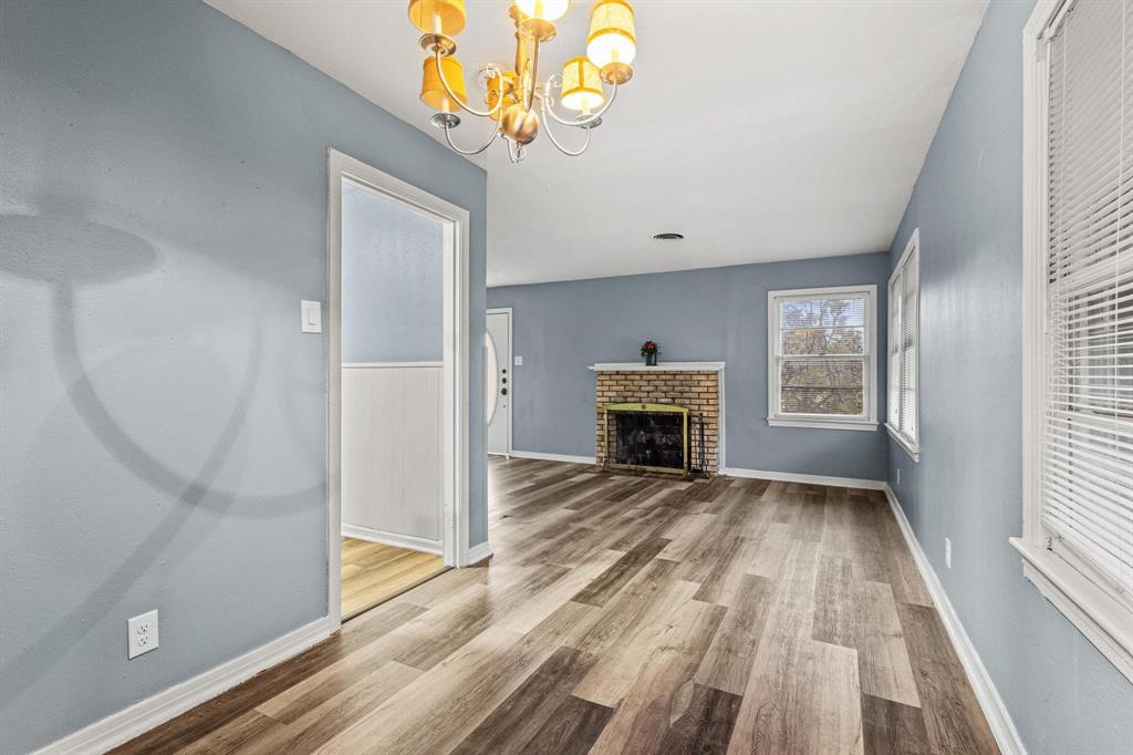 531 West Bullock Street Denison, TX 75020 - Photo 10 of 28 wooden floor with fireplace in livingroom with wooden floor