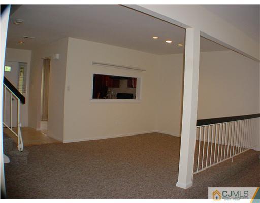 2202 Timber Oaks Road Edison, NJ 08820 - Photo 4 of 10 a view of a hallway with wooden floor