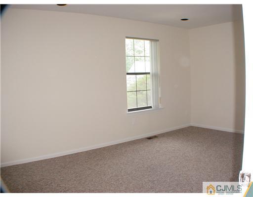 2202 Timber Oaks Road Edison, NJ 08820 - Photo 8 of 10 an empty room with windows