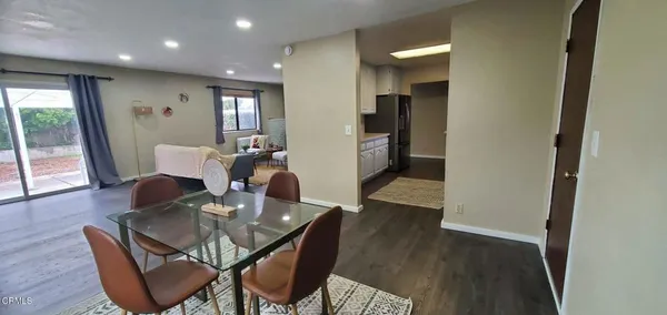 a dining room with furniture and wooden floor