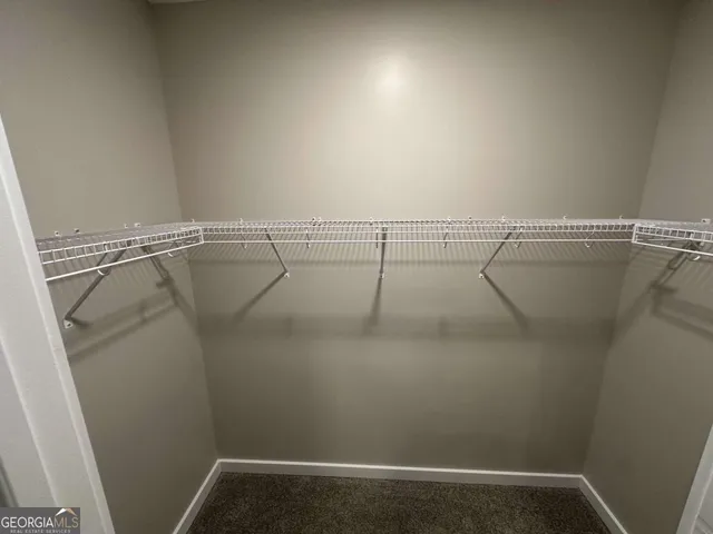 a view of a patio with couches and table and chairs with wooden floor and fence