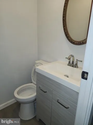 a bathroom with a toilet a sink and mirror