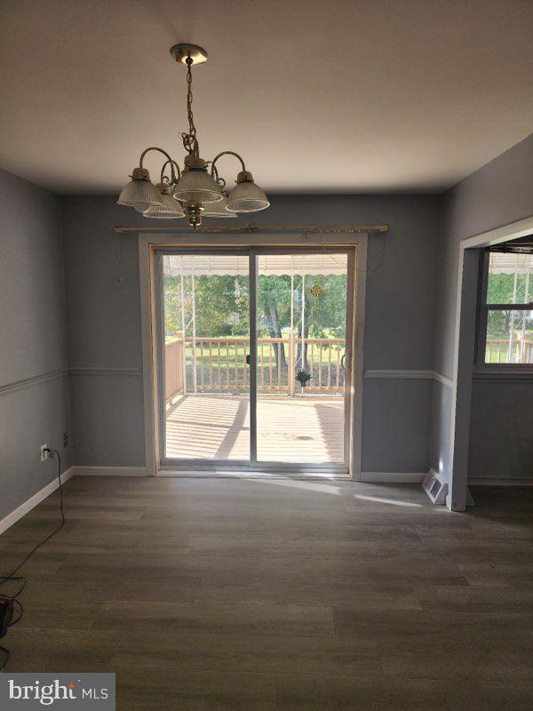 12322 Wyndom Road Philadelphia, PA 19154 - Photo 2 of 13 a view of an empty room with wooden floor and a window