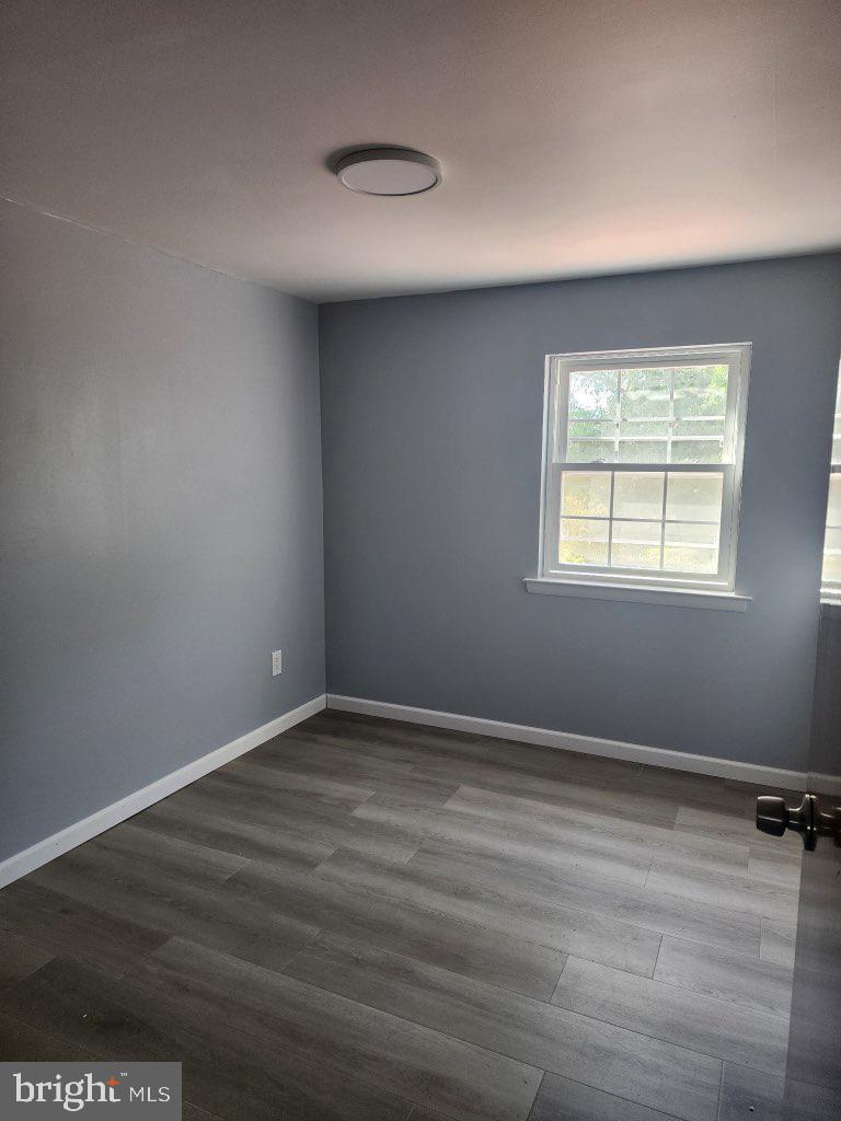 12322 Wyndom Road Philadelphia, PA 19154 - Photo 9 of 13 an empty room with wooden floor and windows